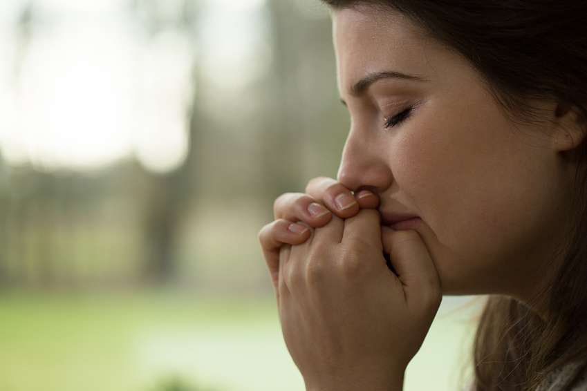 Horizontal view of depressed young woman crying